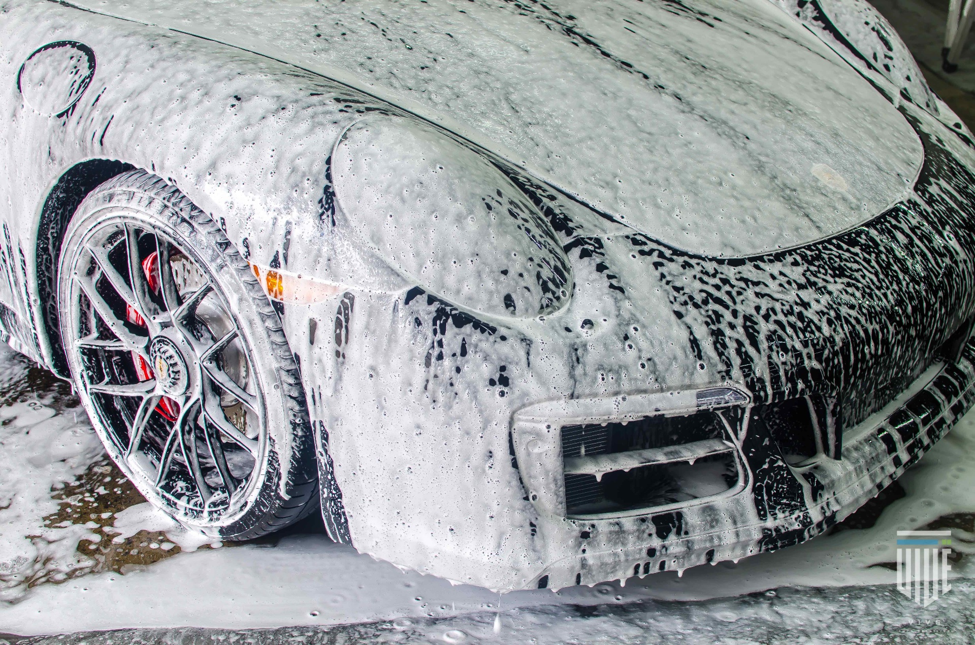 Car covered in thick foam during a foam bath wash