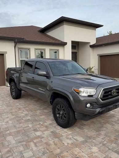 Gray Toyota Tacoma clean and glossy in a suburban driveway